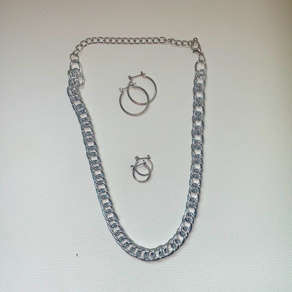 Silver necklace with complementary silver earrings